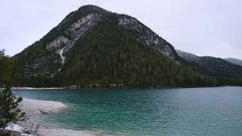Panoramic view of turquoise water alpine lake Lago di Braies in Dolomities Stock Footage 263951280