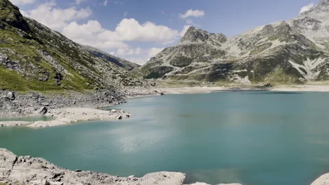 Panoramic view of turquoise water from Monte Spluga Lake dam - Italy Stock Footage 328400068
