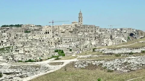 Panoramic view of typical stones Sassi di Matera and church of Matera under sky Video stock 77339330