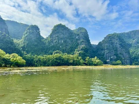 Panoramic view of undulating limestone mountains by the quiet riverbanks Stock Photos