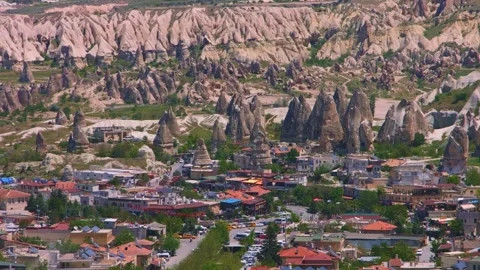 Panoramic view of the unique volcanic rock formations and a town in Cappadocia, Stock Footage 332547947