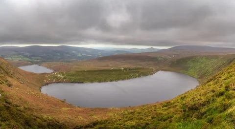 Panoramic view on upper and lower lakes Lough Bray, Sugarloaf and mountain range Stock Photos