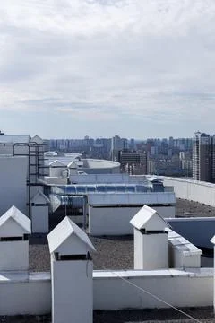 A Panoramic View of Urban Rooftops Surrounded by Modern High-Rise Buildings and Stock Photos