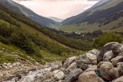 Panoramic view of a valley with a mountain stream running in the rocks Stock Photos