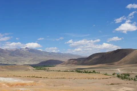 A panoramic view of the valley in the mountains in changeable weather. Stock Photos