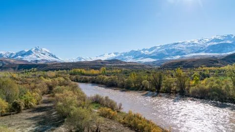 Panoramic view of a valley with snow capped mountains and River Euphrates nea Stock Photos
