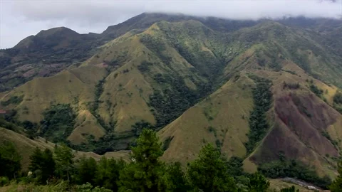 Panoramic View of Vast Green Mountain Range and Deep Valleys under Clouds. Stock Footage 329504810