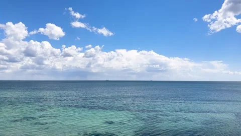 Panoramic view of the vast turquoise sea with gentle water ripples 스톡 동영상 335887455