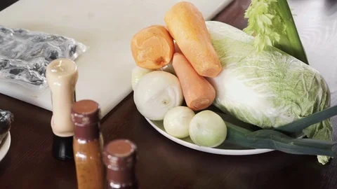 Panoramic view of vegetables and fish on a kitchen table professional chief Stock Footage 73210520
