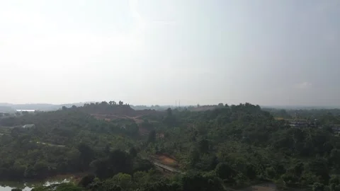 Panoramic view of verdant hills and distant settlements under a hazy sky Stock Footage 319459699