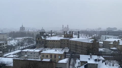 Panoramic view of Vilnius city center during snowfall from Gyneju street Stock Footage 152772967