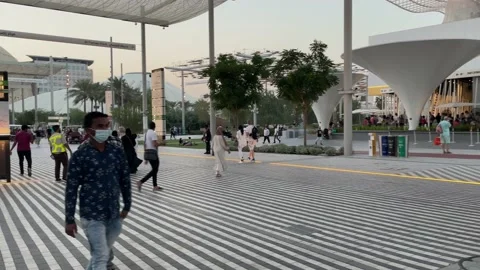 Panoramic view Visitors roaming around Expo 2020 in the evening Stock Footage 163637433