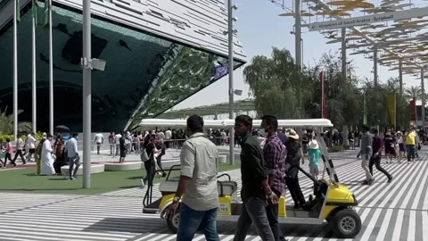 Panoramic view Visitors roaming around Expo 2020 in the evening Stock Footage 171760637