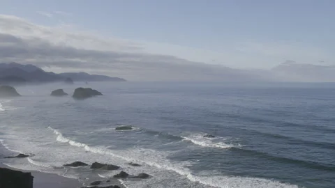 Panoramic view of waves crashing against rocky oregon beach Stock Footage 332255299