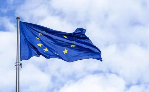 Panoramic view of a waving EU flag or European Union flag against blue sky Stock Photos