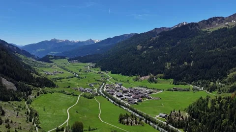 Panoramic View of Wide Green Valley with Village and Mountain Range Video stock 343489176