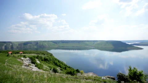 Panoramic view of the wide river with steep banks, forest, blue sky with white Stock Footage 159430330