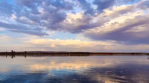 Panoramic view of wide steppe river with a calm current Stock Photos