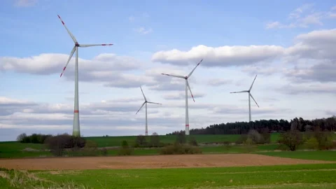 Panoramic view of wind farm or wind park on sunny day, with high wind turbines Stock Footage 184923409