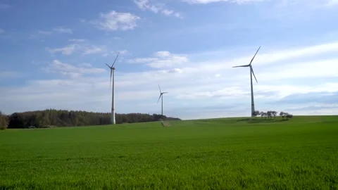 Panoramic view of wind farm or wind park on sunny day, with high wind turbines Stock Footage 188460591