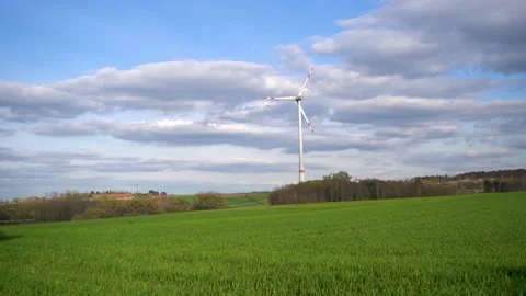 Panoramic view of wind farm or wind park on sunny day, with high wind turbines Stock Footage 188460793