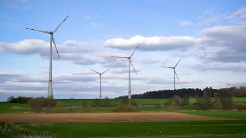 Panoramic view of wind farm or wind park on sunny day, with high wind turbines Stock Footage 188460850