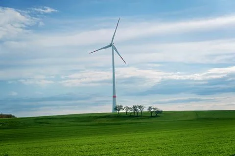 Panoramic view of wind farm or wind park on sunny day, with high wind turbines Stock Photos