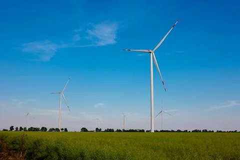 Panoramic view of wind farm or wind park, with high wind turbines for generat Stock Photos