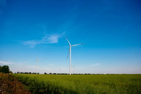 Panoramic view of wind farm or wind park, with high wind turbines for generat Stock Photos