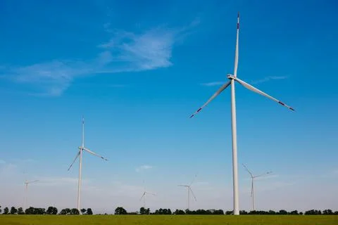 Panoramic view of wind farm or wind park, with high wind turbines for generat Stock Photos