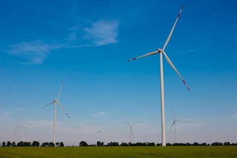Panoramic view of wind farm or wind park, with high wind turbines for generat Stock Photos