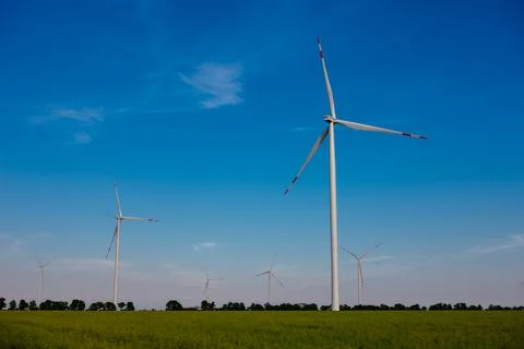 Panoramic view of wind farm or wind park, with high wind turbines for generat Stock Photos