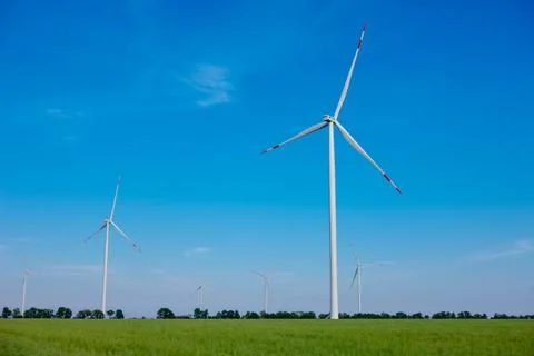 Panoramic view of wind farm or wind park, with high wind turbines for generat Stock Photos