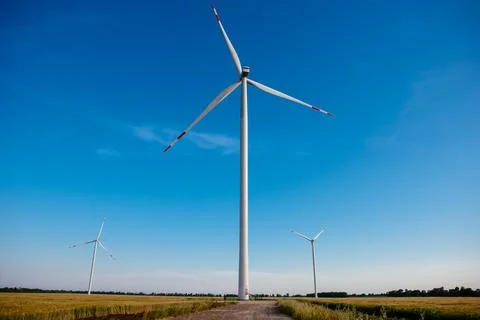 Panoramic view of wind farm or wind park, with high wind turbines for generat Stock Photos