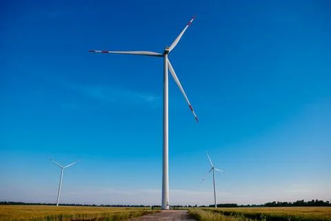 Panoramic view of wind farm or wind park, with high wind turbines for generat Stock Photos
