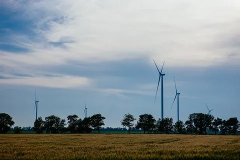 Panoramic view of wind farm or wind park, with high wind turbines for generat Stock Photos