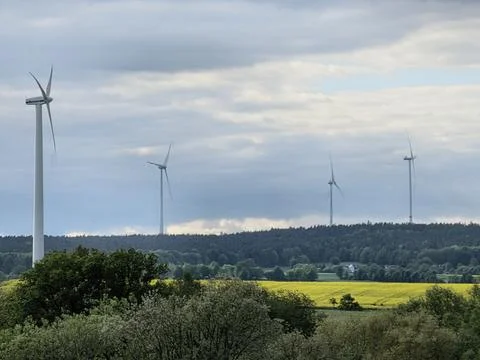 Panoramic view of wind farm or wind park, with high wind turbines for generation Stock Photos