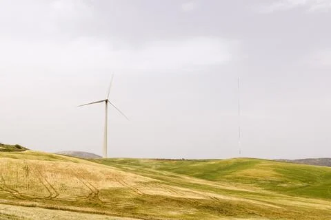 Panoramic view of a wind farm. Wind park with tall wind turbines to generate Stock Photos