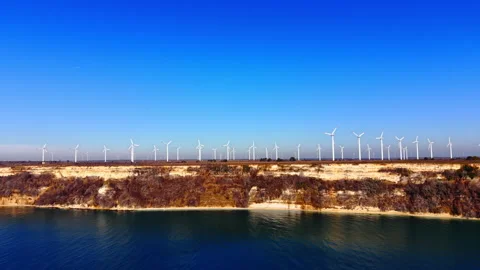 Panoramic view of wind turbines on high sea cliffs Video stock 329623570