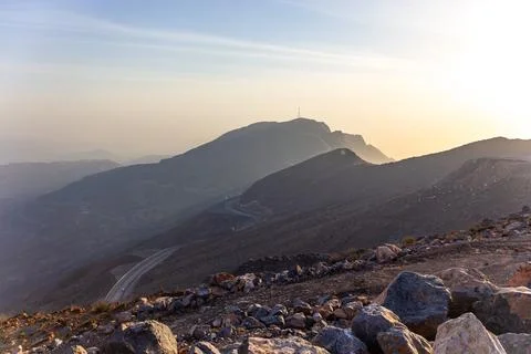 Panoramic View of Winding Mountain Road at Sunset Stock Photos
