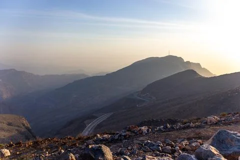 Panoramic View of Winding Mountain Road at Sunset Stock Photos