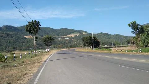Panoramic view of a winding road with views of hills and green trees Stock Photos