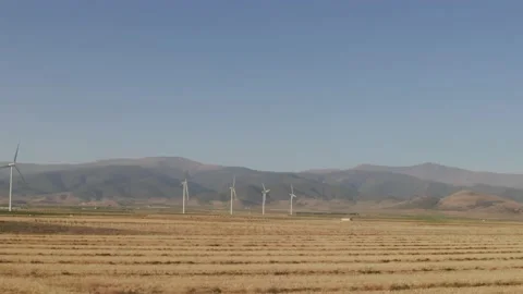 Panoramic view of windmills on a field Stock Footage 156233186