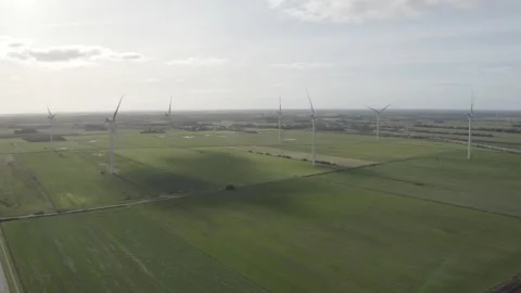 Panoramic view of windmills in a large green field Stock Footage 165877739