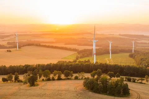 Panoramic view of windmills or wind turbines for electricity production at Stock Photos