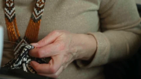Panoramic view of woman's hands in focus sewing with needles and stitching Stock Footage 118956582