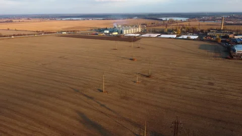 Panoramic view of yellow dry wheat field after harvest, grain elevator Stock Footage 330679292