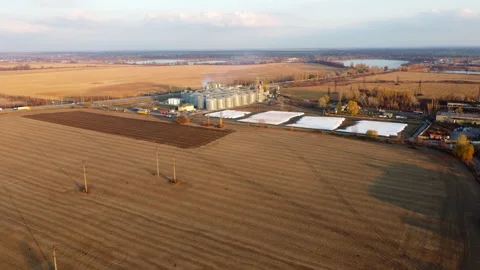Panoramic view of yellow dry wheat field after harvest, grain elevator Stock Footage 330679479