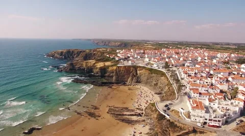 Panoramic view of Zambujeira de Mar and beach with holidaymakers people aerial Video stock 66682184