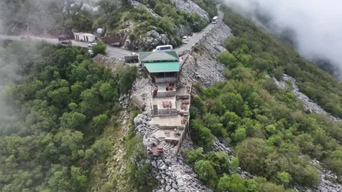 Panoramic views above Kotor on a winding mountain road amidst lush greenery and Video stock 287755953